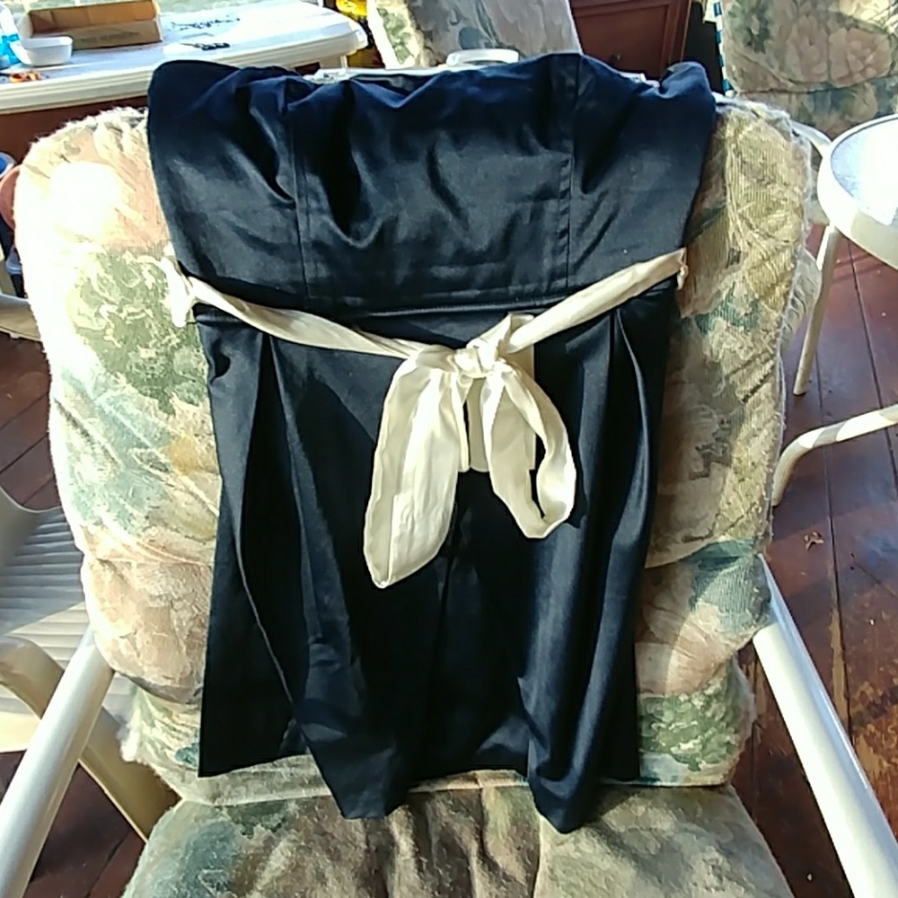 Navy blue dress, strapless with white bow.